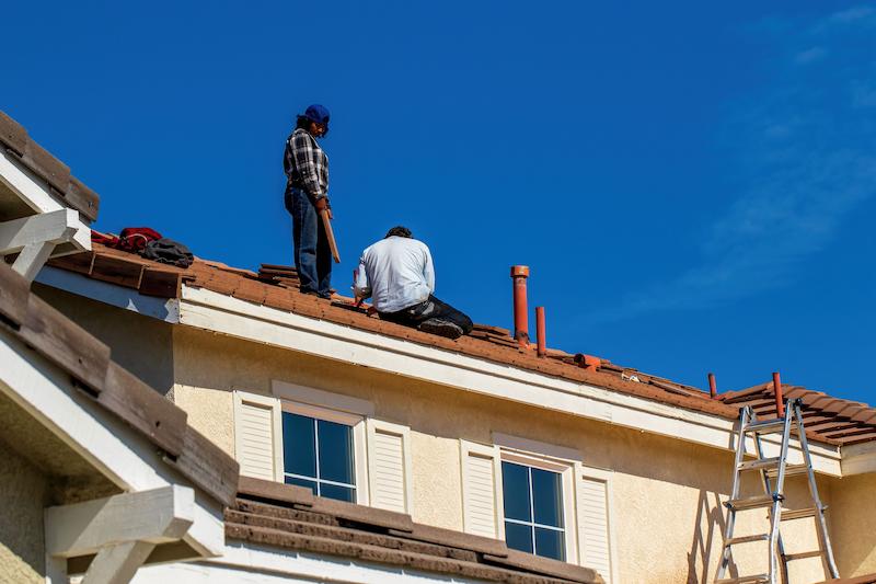 Roofing crew working on a residential roof in Texas